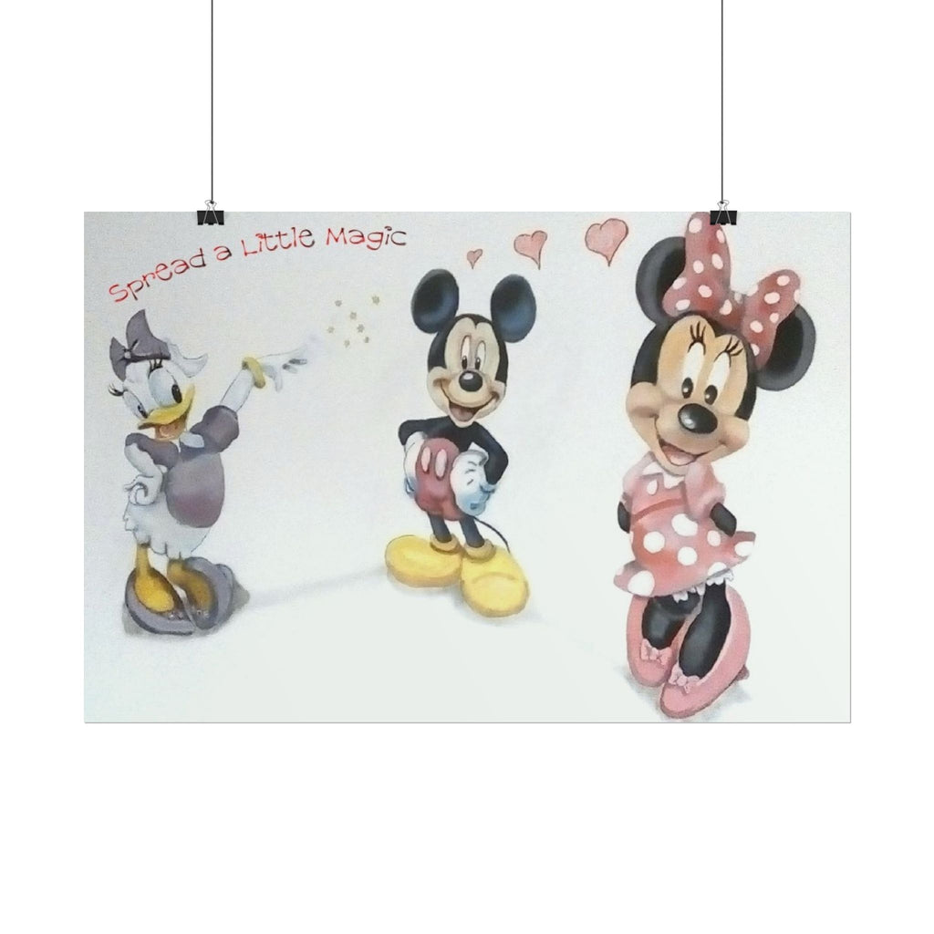 A rectangular wall art print featuring Disney characters Mickey Mouse, Minnie Mouse, and Daisy Duck on a white background, with the phrase 'Spread a little Magic' in red script. The print is shown hanging from two black clips against a light gray wall.